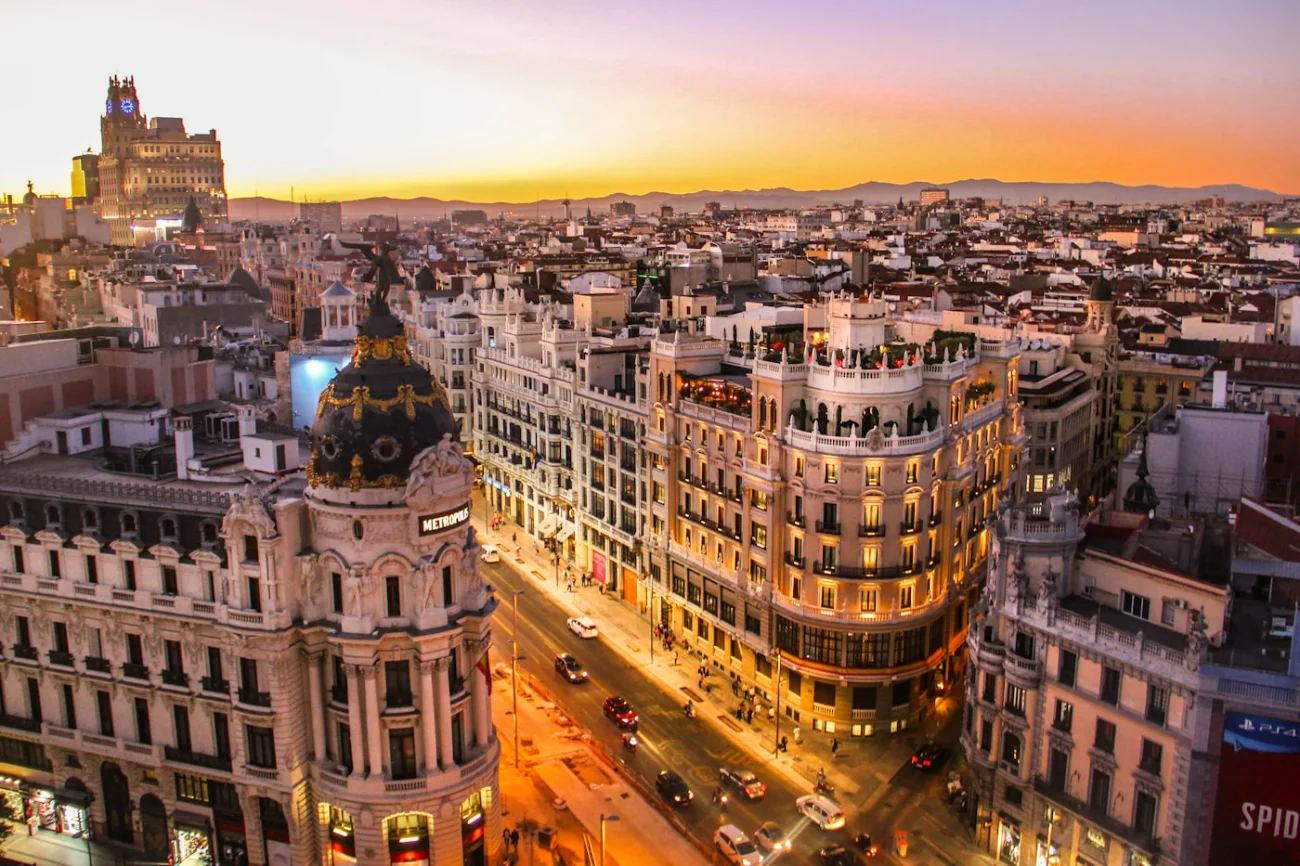 Neighborhood street at dawn with golden light — the city that still has a soul for those who know how to see it